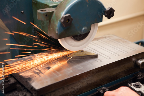 Sparks flying as a piece of metal is being cut photo
