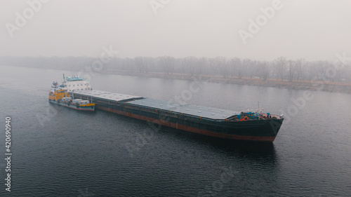 Top-view of two cargo ships like a child and it's parent photo