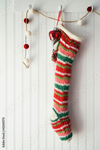 Knitted christmas stocking hanging on hook
