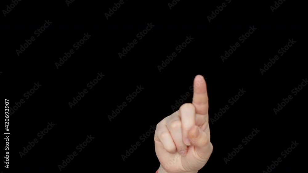 Close-up view of female finger touching something on black background. Cropped shot of hand pointing with finger at copy space on black background Close-up view of female finger touching something on black background. Cropped shot of hand pointing with finger at copy space on black background