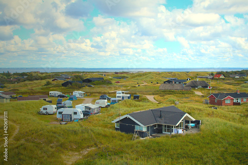 Fototapeta Holiday homes and caravans at camping site among dunes (Hvide Sande, Jutland, De