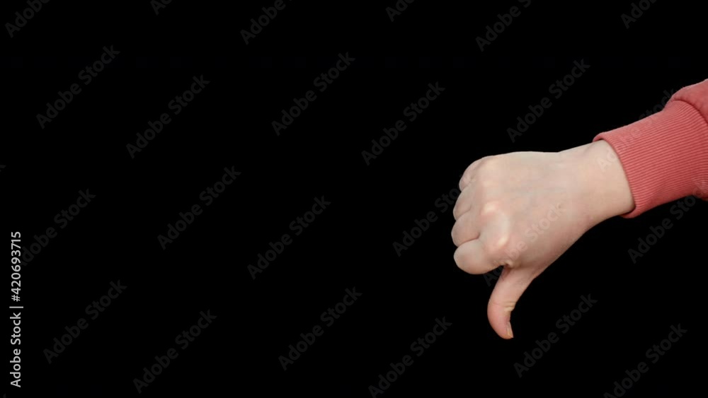 Close-up view of woman showing thumb down gesture on black background. Unhappy dissatisfied woman showing thumb down dislike gesture critiquing bad Close-up view of woman showing thumb down gesture on black background. Unhappy dissatisfied woman showing thumb down dislike gesture critiquing bad