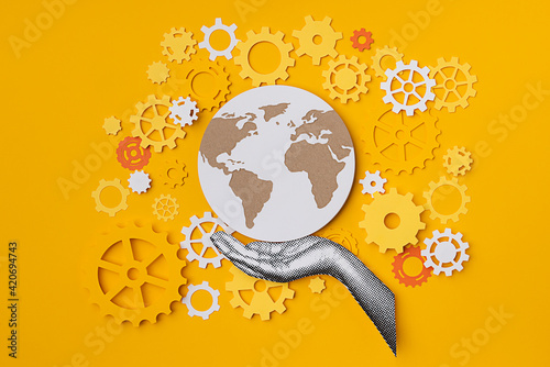 Hand holding the world with gears photo