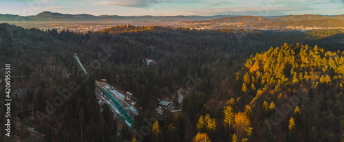 Early morning drone panorama photo of contemporary ski jumps in Mostec, Ljubljana. View of an old ski jumping hill in the Slovenian city. photo