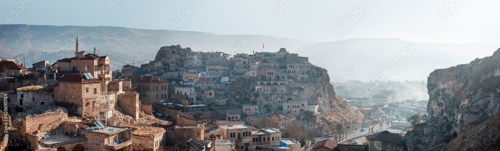 Turkey, Urgup - November 2020: Panarama of the city in the morning from the mountain. View of the old stone mansions located in the gorge