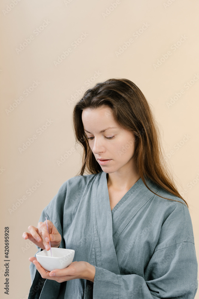 Woman preparing mask for skin care treatment Woman preparing mask for skin care treatment