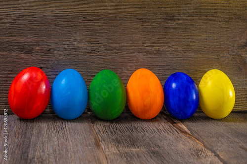 Easter eggs on dark wooden table against wooden background