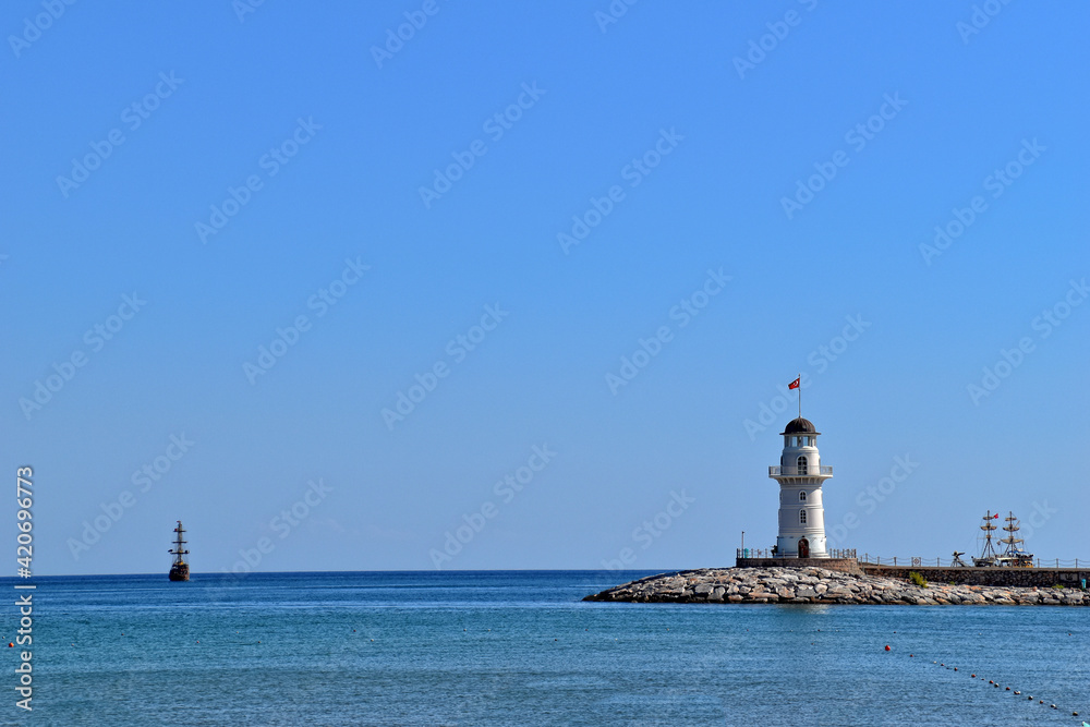 landscape of the port in the Turkish city of Alanya with the white tower on a warm summer day