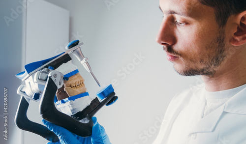 Dental Technician Making New Dental Prosthetics in Laboratory.