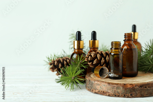 Aromatherapy concept with pine oil on white wooden table