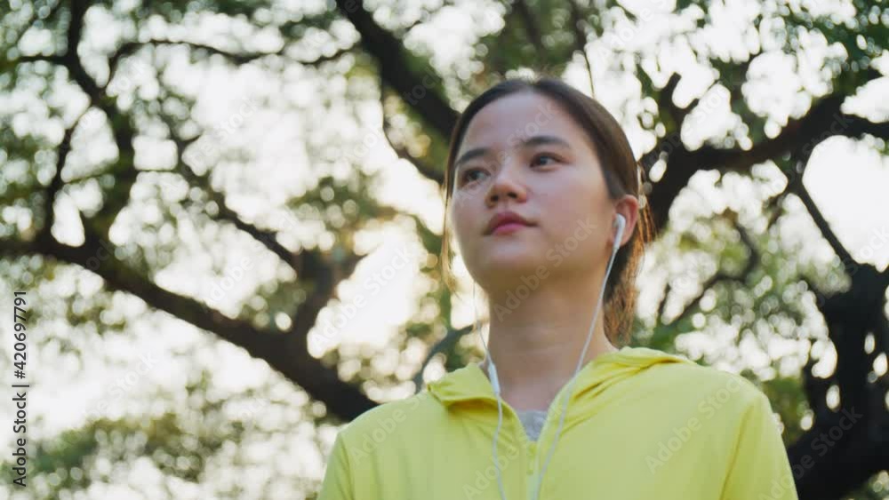 Attractive of beautiful young Asian woman walking cardio workout in the park. Attractive of beautiful young Asian woman walking cardio workout in the park.