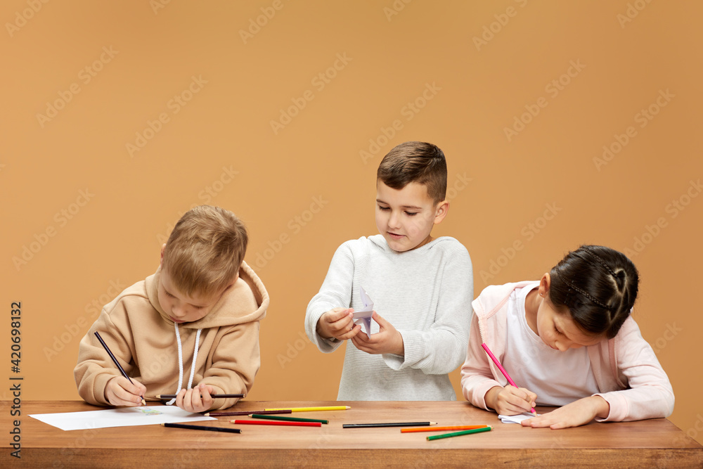 happy children draw together at the table happy children draw together at the table