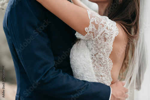 bride and goom holding each other close photo