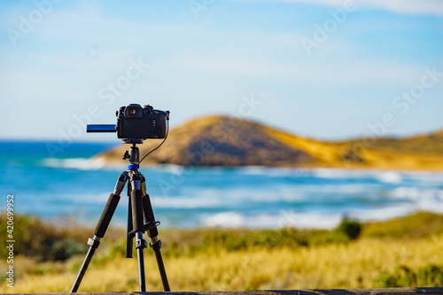 Camera taking picture of sea coast landscape