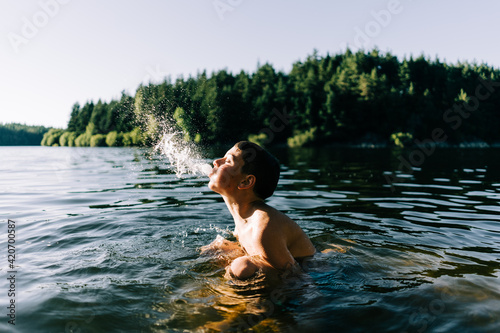 boy spitting water out photo