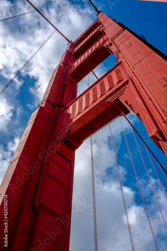 Close up of single tower of Golden Gate Bridge in white clouds San Francisco, USA, bottom view