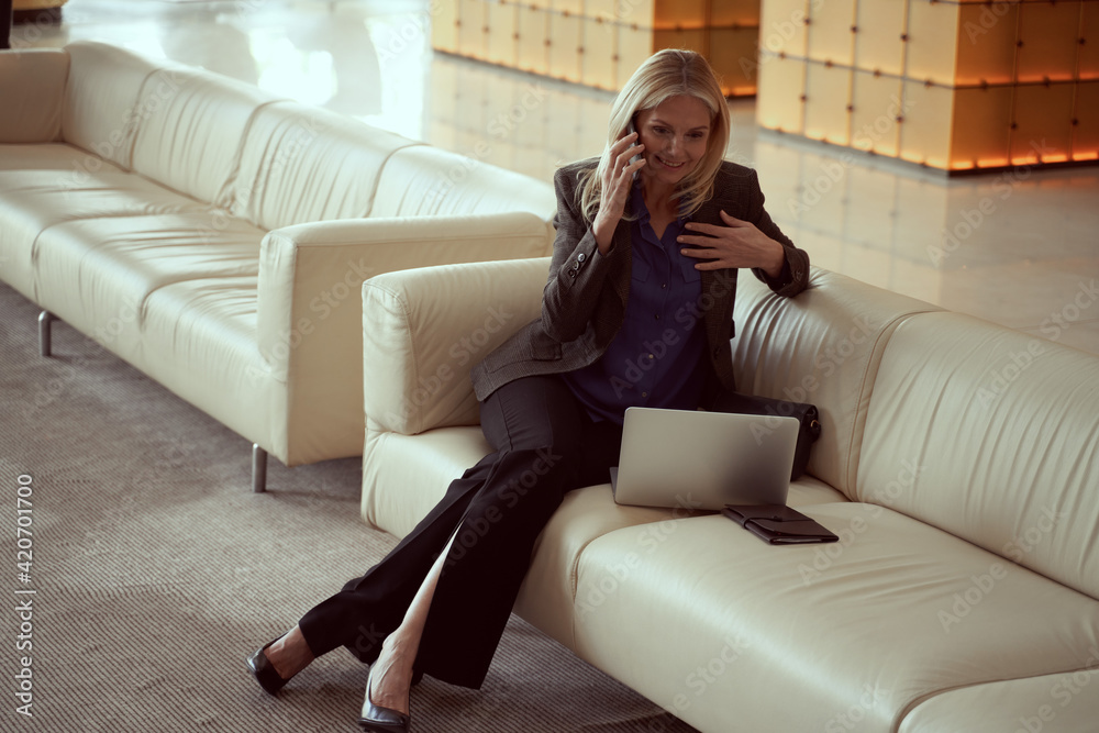 Obraz premium Business woman looking happy receiving good news on the phone