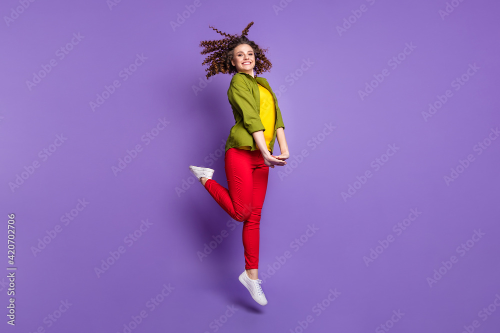 Full size photo of young attractive pretty cute smiling cheerful good mood girl jumping isolated on violet color background
