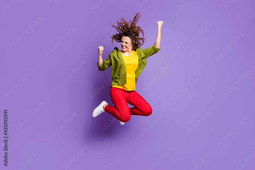 Full size photo of young crazy excited smiling funky girl jumping in victory success isolated on violet color background