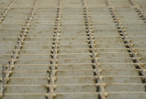 Metal grating walkway with low angle view.