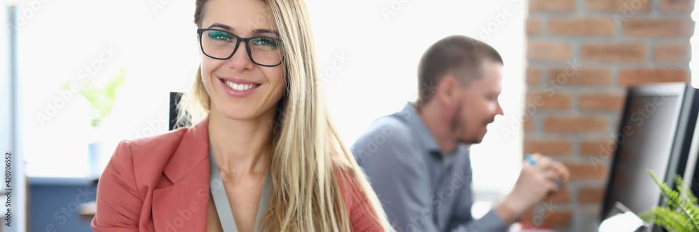 Man and woman sit at workplace at computers and study. Man and woman sit at workplace at computers and study.