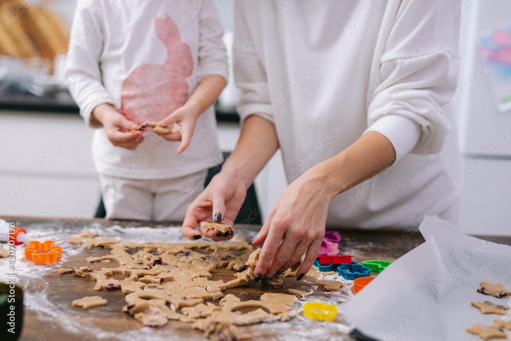 Mother teaching daughter baking biscuits
