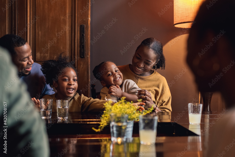 A Family Laughing in a Restaurant A Family Laughing in a Restaurant
