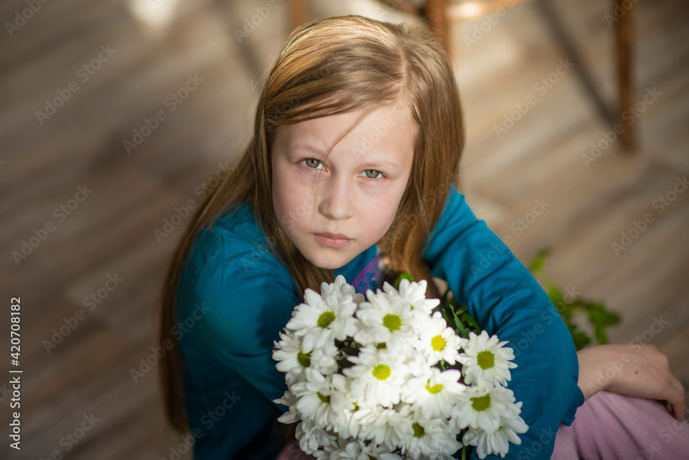girl with blonde hair with white chrysanthemum flowers, selective focus
