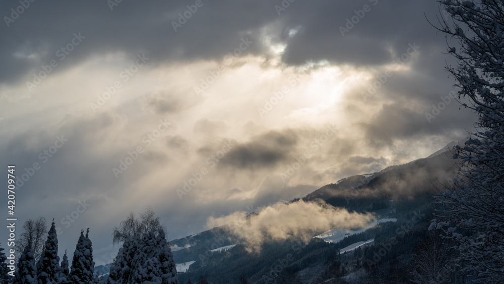 fog, sun and clouds in the morning with fresh snow in the mountains fog, sun and clouds in the morning with fresh snow in the mountains