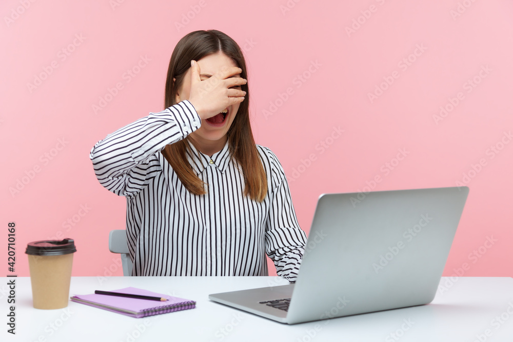 Excited woman office worker closing eyes with hand and smiling talking on video call sitting at workplace, waiting for surprise. Indoor studio shot isolated on pink background Excited woman office worker closing eyes with hand and smiling talking on video call sitting at workplace, waiting for surprise. Indoor studio shot isolated on pink background