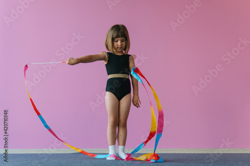 Aesthetics of gymnastics. Pink, black and gold colors. Rainbow ribbon photo