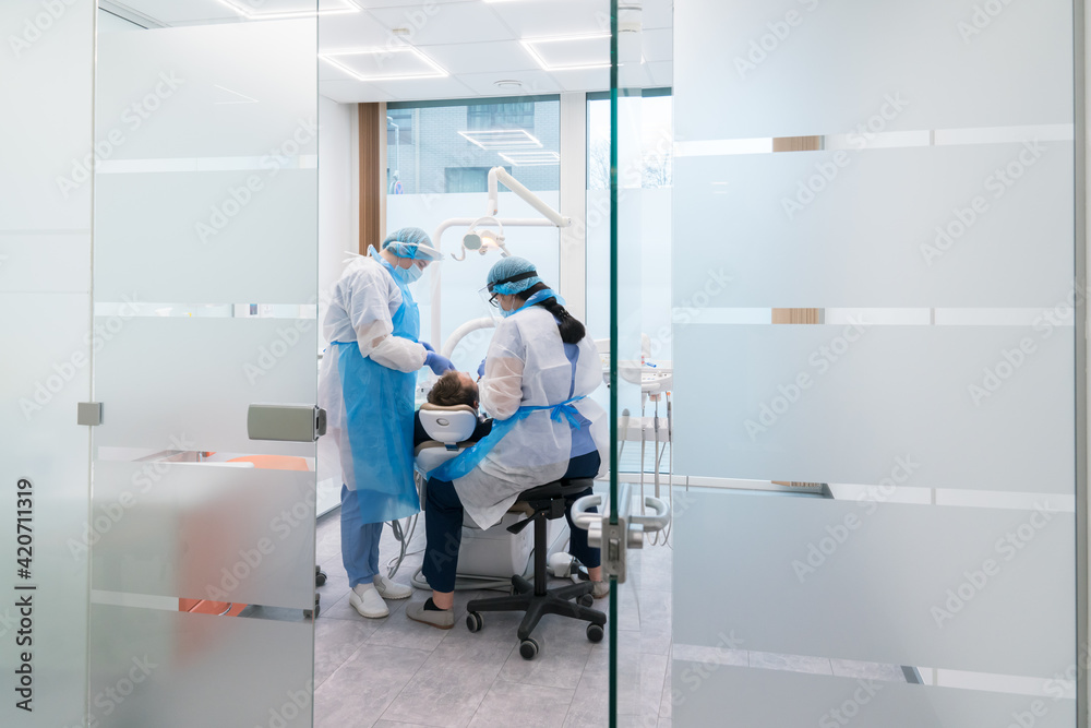 Dentists With A Patient During A Dental Intervention