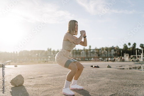 Woman doing a squat with resistance bands