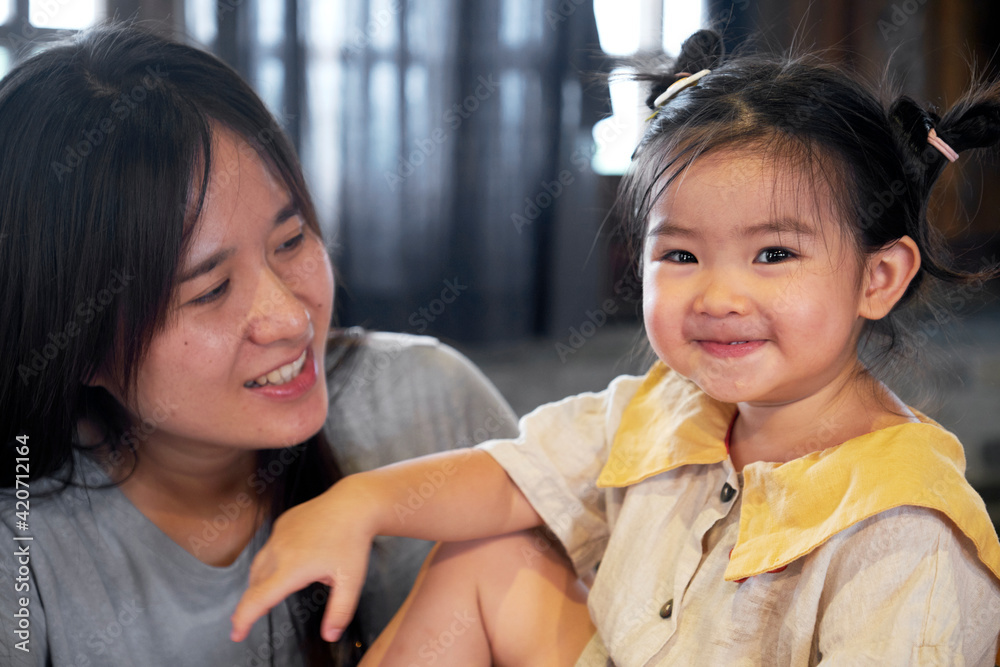 Beautiful cute Asian little girl playing happily with her mother Beautiful cute Asian little girl playing happily with her mother
