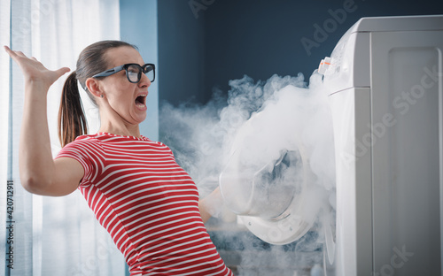 Konstfotografi Scared woman and burning appliance at home