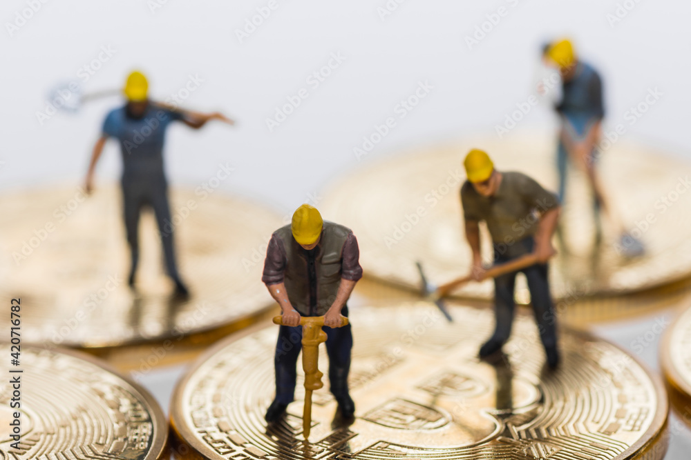 four miners working on bitcoin crypto currency detail four miners working on bitcoin crypto currency detail