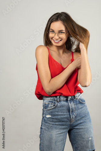 sweet smiling girl with eye glasses and red shirt