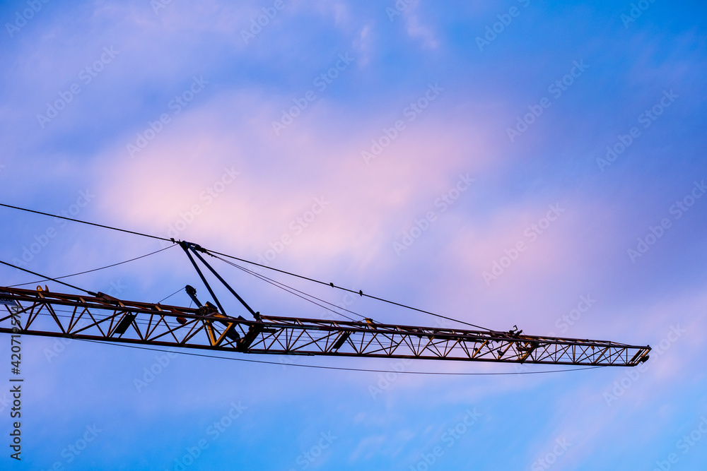 Crane girder under blue sky clouds