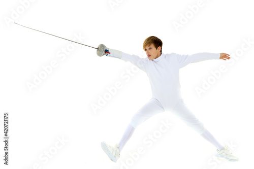 Boy fencer standing in attacking pose
