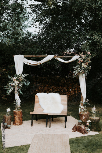 Wooden wedding arch with flowers photo