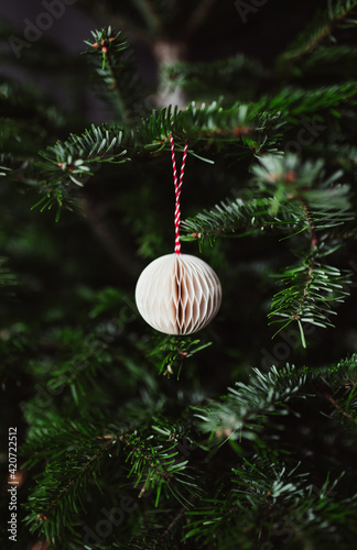 A Christmas tree with white ornament photo