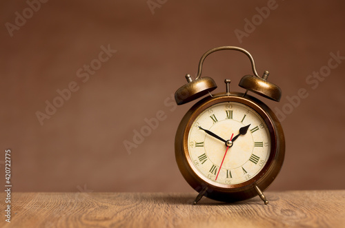 old alarm clock on wooden table