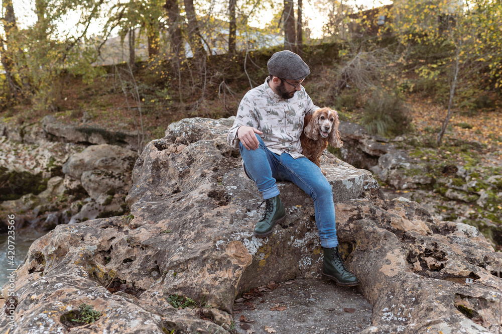 Young alternative man giving affection to his pet Young alternative man giving affection to his pet