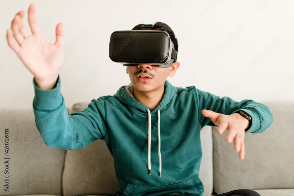 Asian Man Uses VR Headset Asian Man Uses VR Headset
