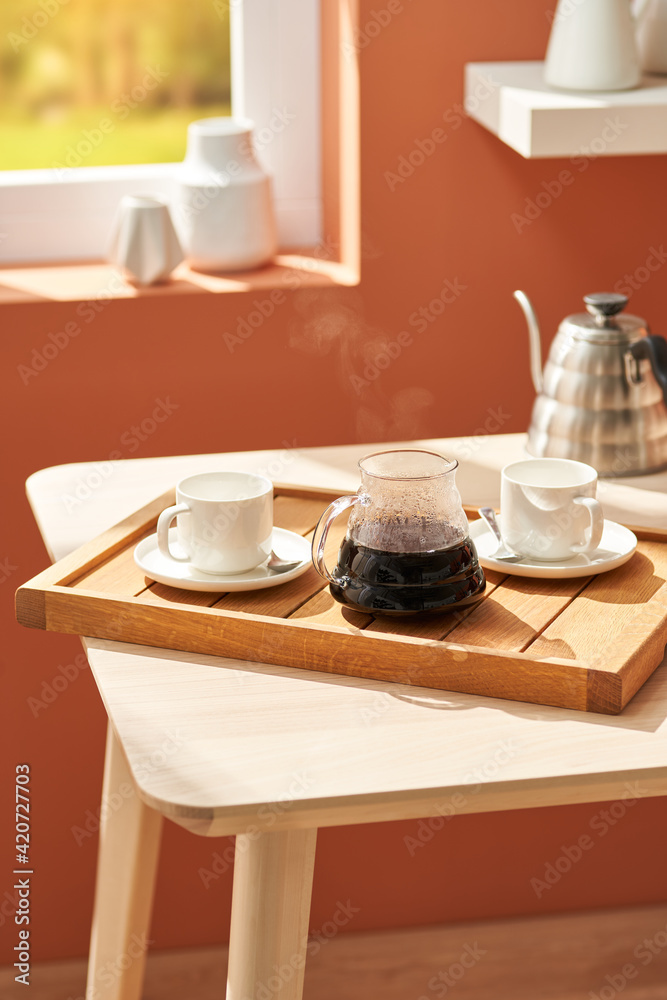 Tray with fresh coffee near window Tray with fresh coffee near window