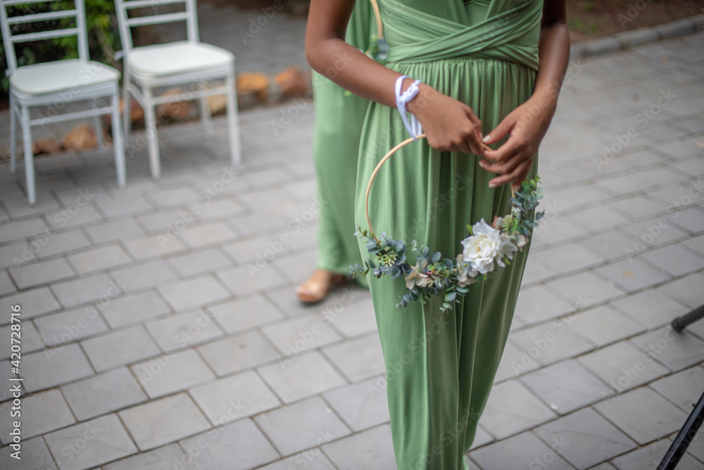 Bridesmaid walking into chapel with flowers