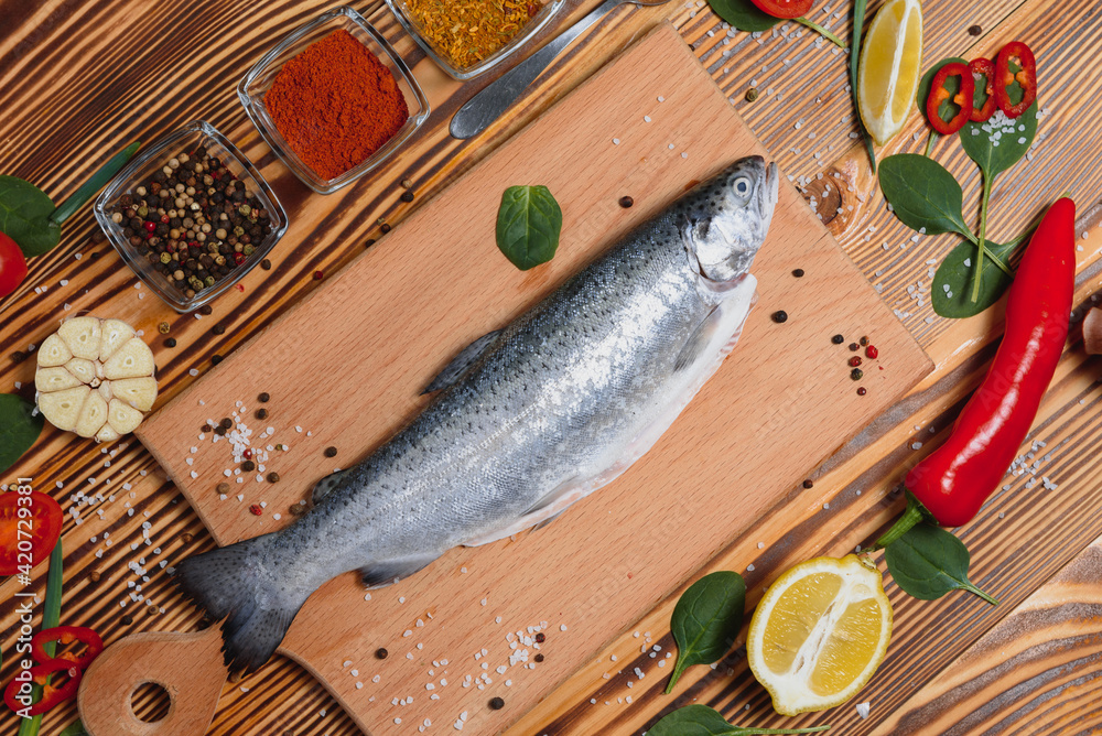 fresh trout with spices and seasonings top view, flat lay fresh trout with spices and seasonings top view, flat lay