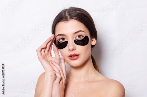 Eye patch, Beautiful Woman With Natural Makeup And Black Hydro Gel Eye Patches On Facial Skin. Caucasian woman use black patches after shower, skin care