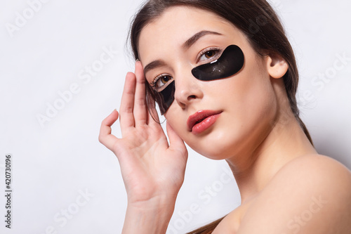Eye patch, Beautiful Woman With Natural Makeup And Black Hydro Gel Eye Patches On Facial Skin.