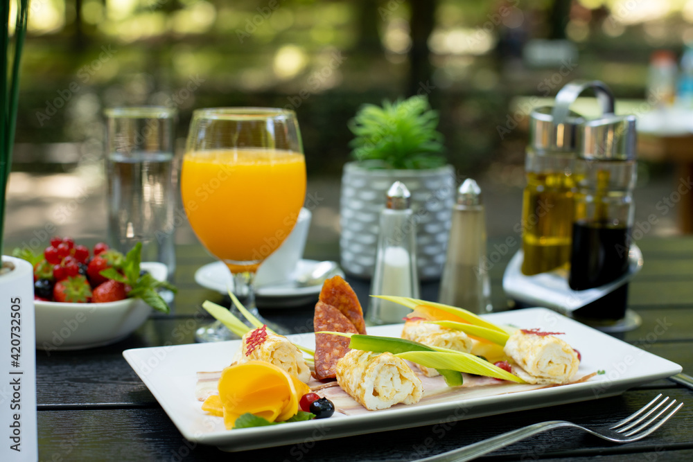 details of delicious outdoor brunch on black wooden table